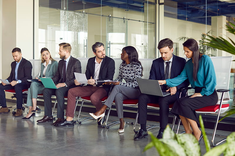 Group of people waiting to be interviewed at a career fair